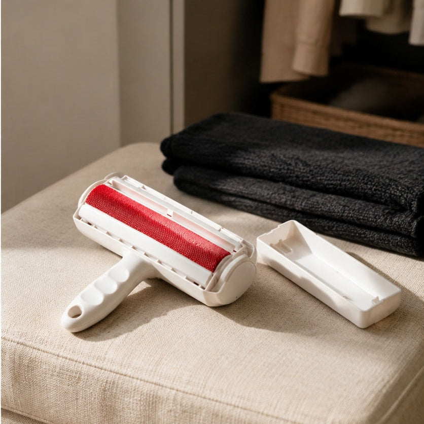Reusable pet hair remover roller and base tray on a linen ottoman